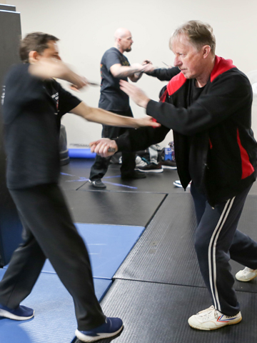 Students training knife skills during workshops.